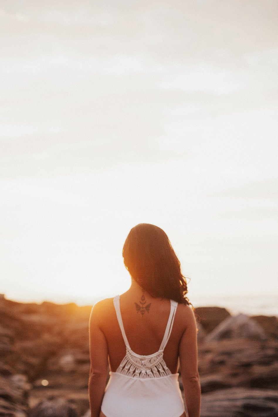 Woman Standing Facing Sunrise